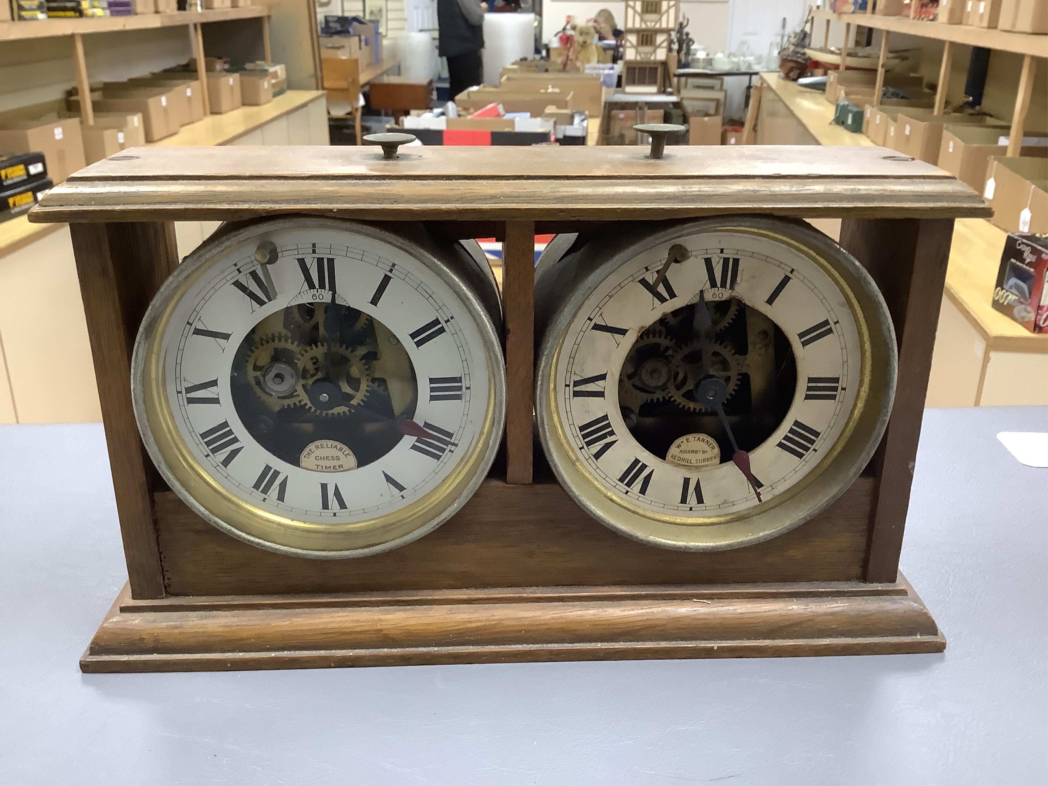 A William Tanner 'The Reliable Chess Timer' in an oak case, stamped to the reverse ‘HAO Make, Made in Wurttemberg’, (a.f.). Condition - poor, some damage and glass missing to one side.